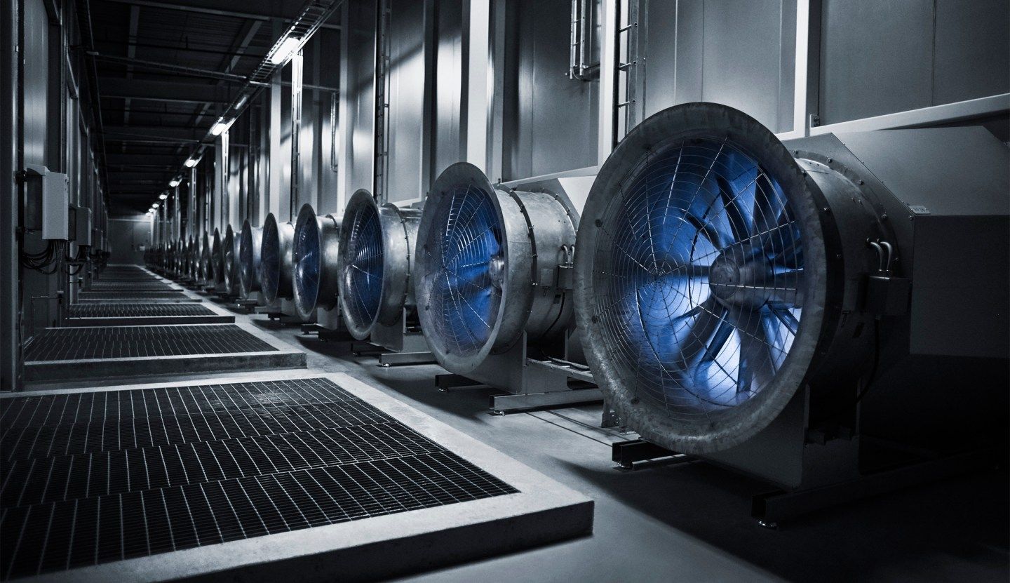 These enormous fans draw in the outside air to cool the servers in the data hall. In the winter, when temperatures plunge to -30 degrees the situation is reversed, and the heat from the servers warm the massive buildings.