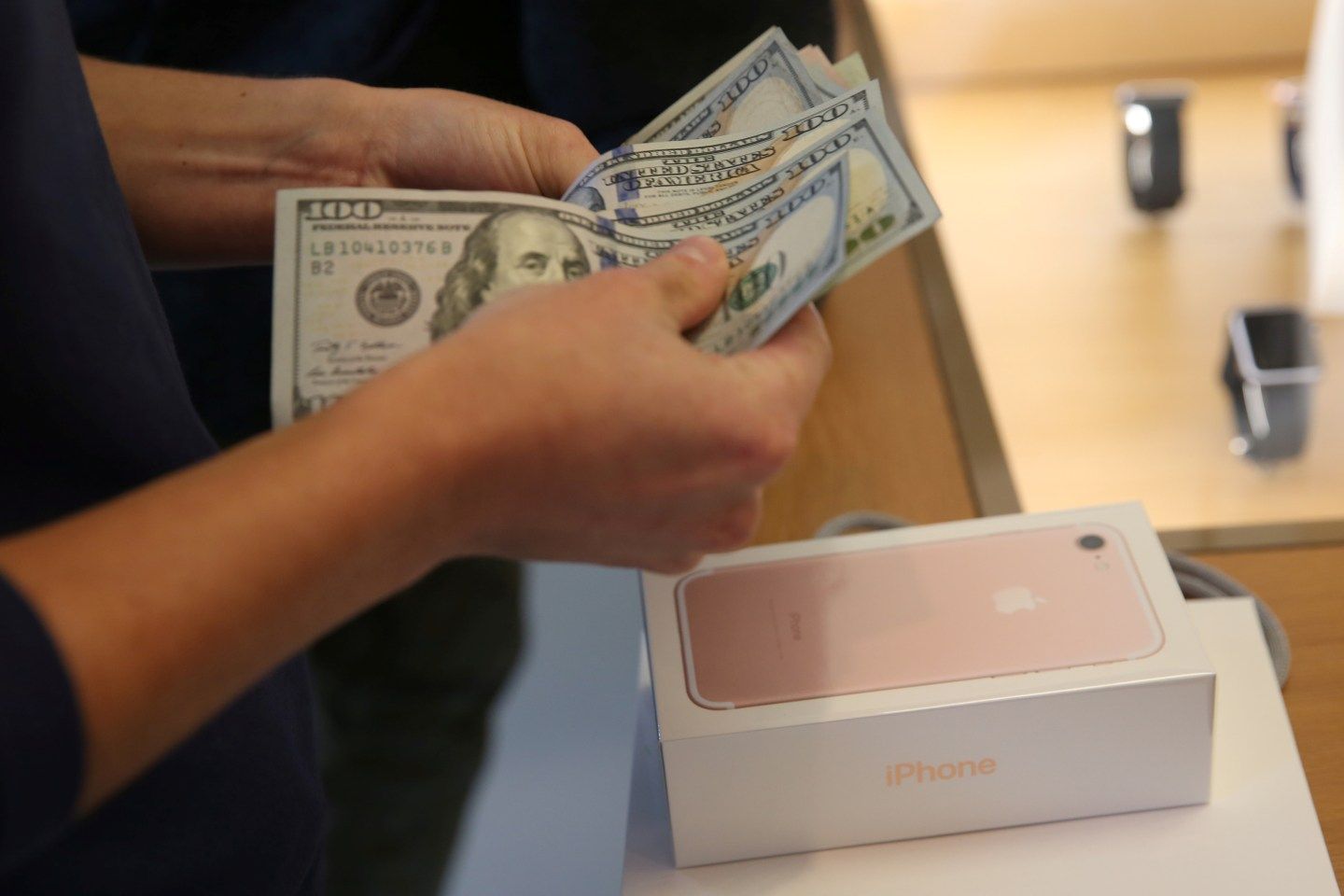 A customer buys the new iPhone 7 smartphone inside an Apple Inc. store in Los Angeles