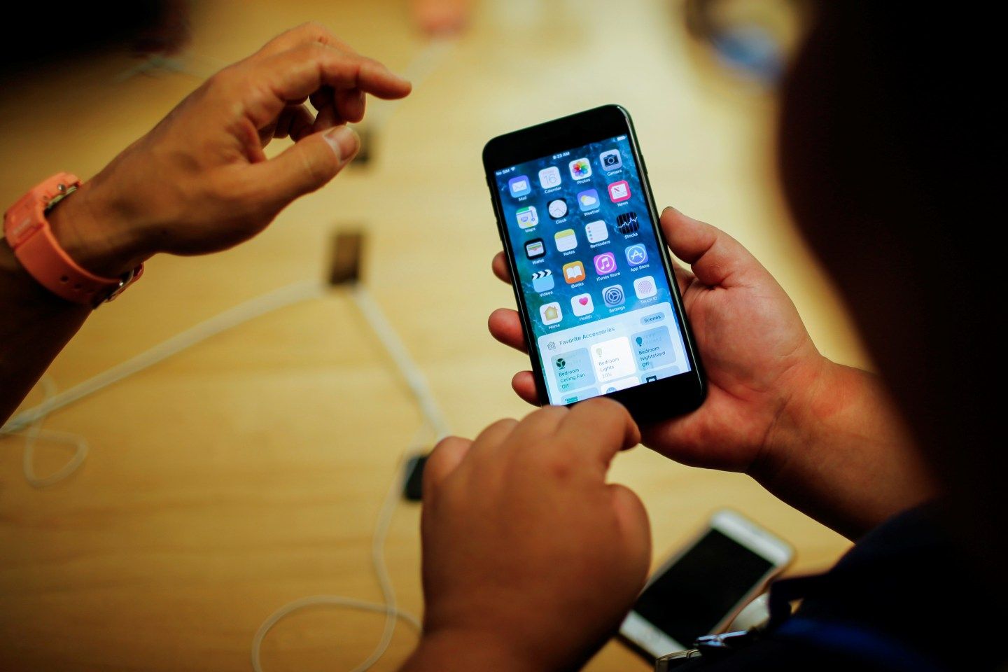 Customers take a look of the new iPhone 7 smartphone inside the Apple Inc. store in New York