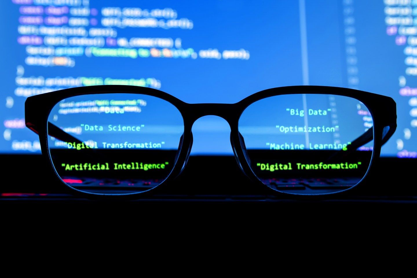 Data scientist , big data , artificial intelligence , machine learning technology concept. Silhouette glasses in front of laptop computer screen with programming coded.