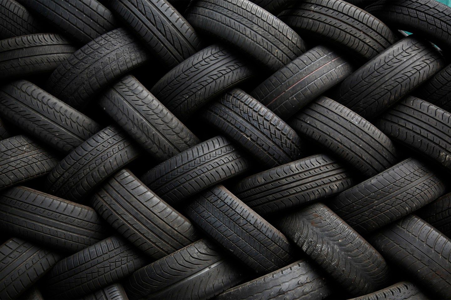 Used car tires form a pattern as they are seen stacked outside an automotive shop in East Dulwich, south London