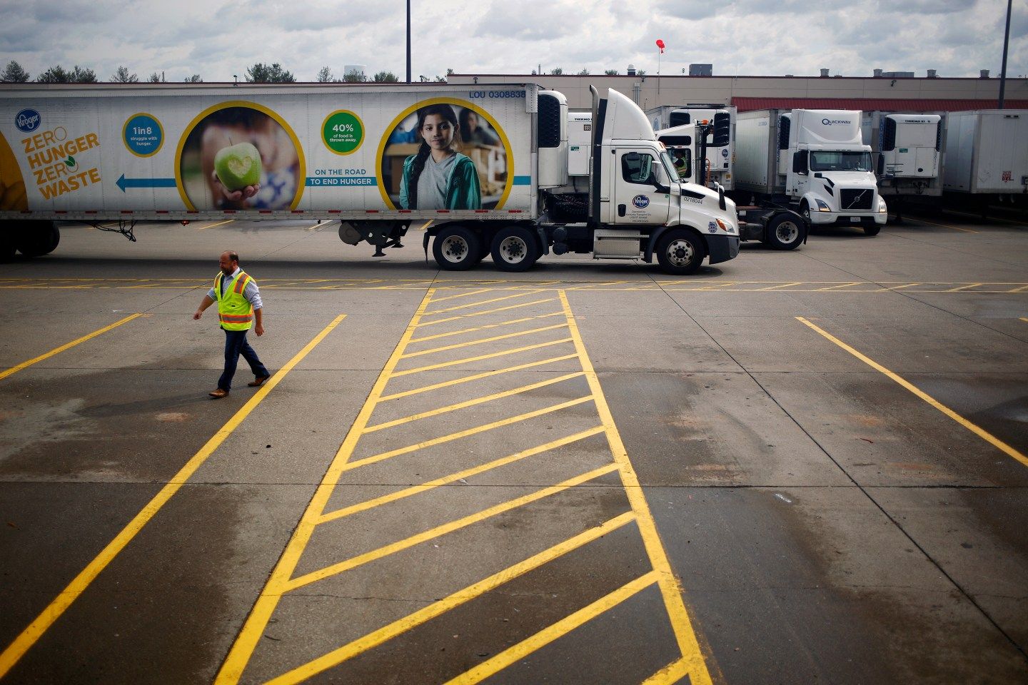 A semi-trailer truck drives through the parking lot of a Kroger Co. grocery distribution center in Louisville, Kentucky on March 20, 2020.