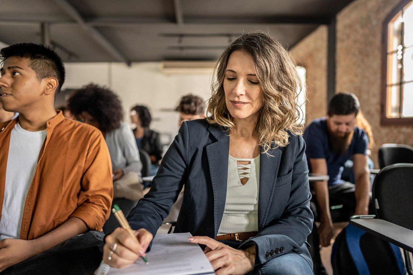 Female student taking notes in classroom