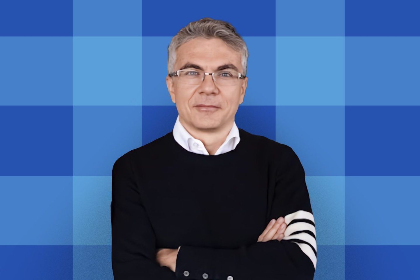 Headshot of Jerome Pesenti, former head of AI at Meta on a blue grid background