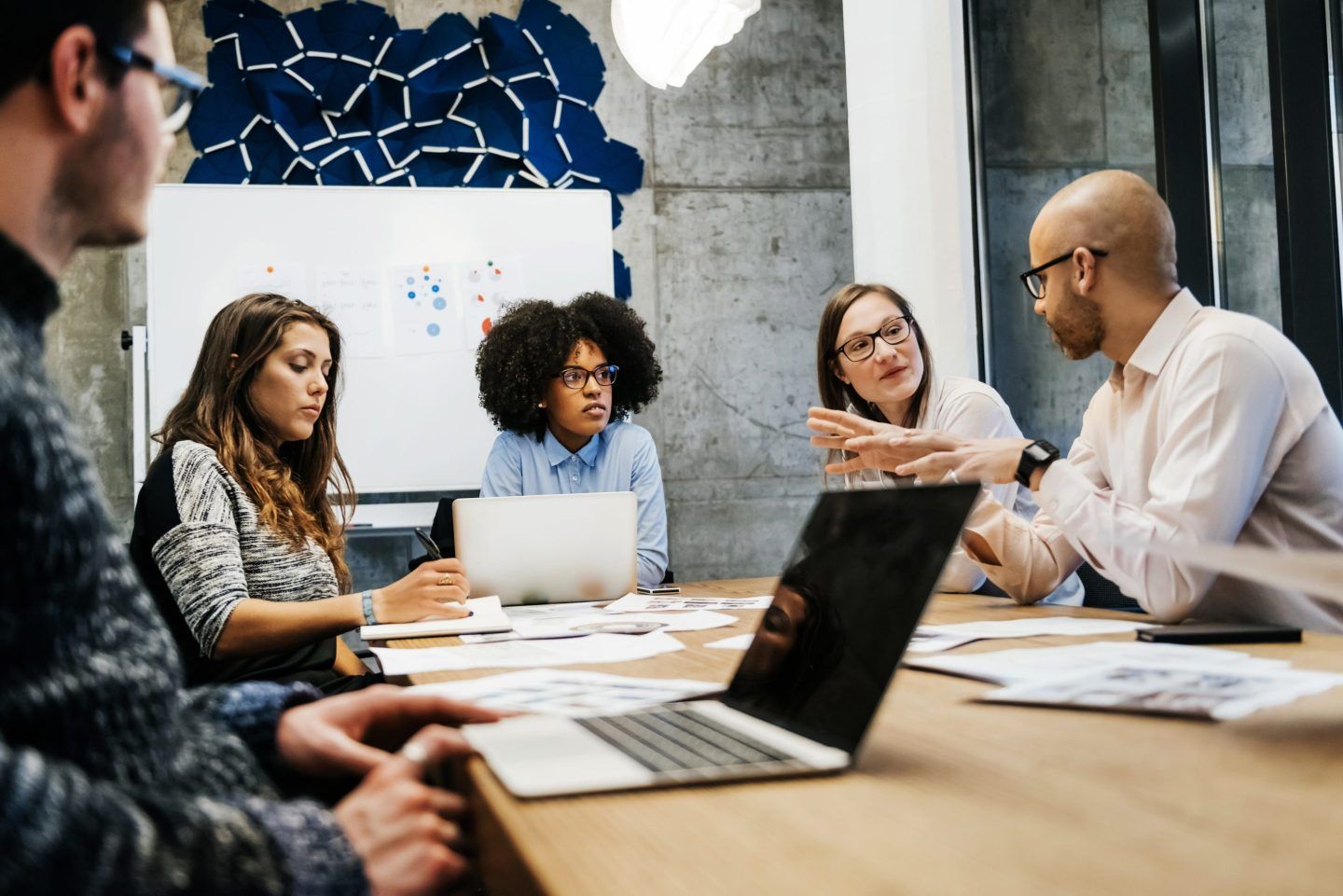 Group of co-workers has a discussion around a conference table