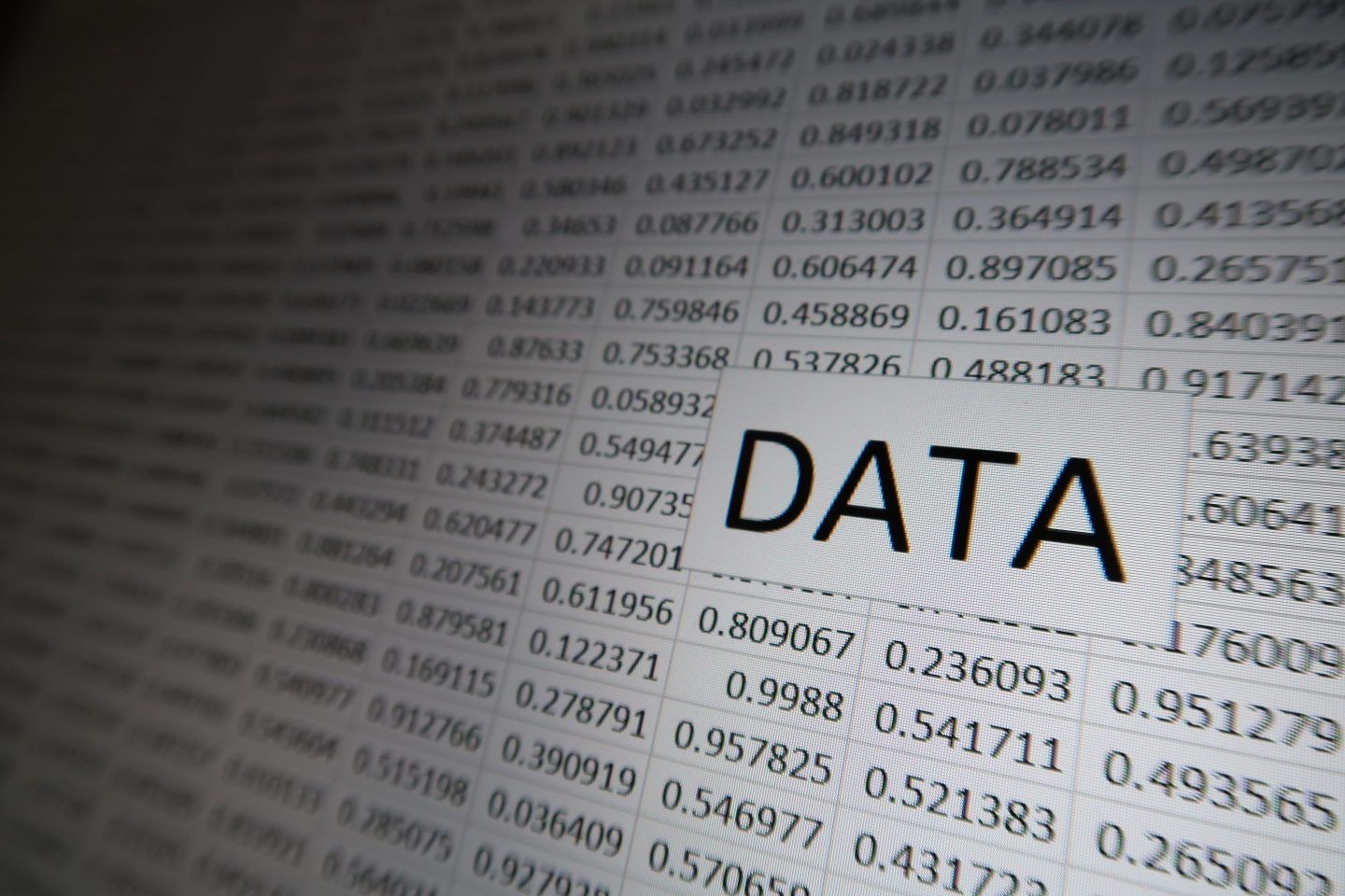 The word "DATA" appears against a grid of random numbers on a digital display