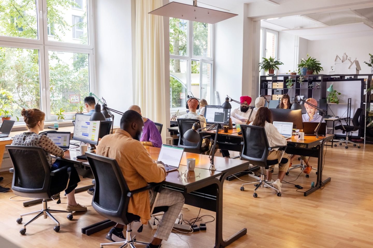 Group of business people work at office tables.