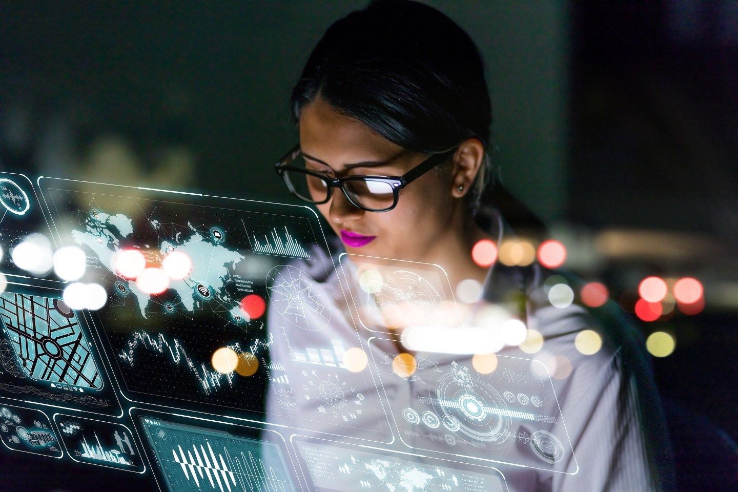 woman engineer looking at various information in screen of futuristic interface
