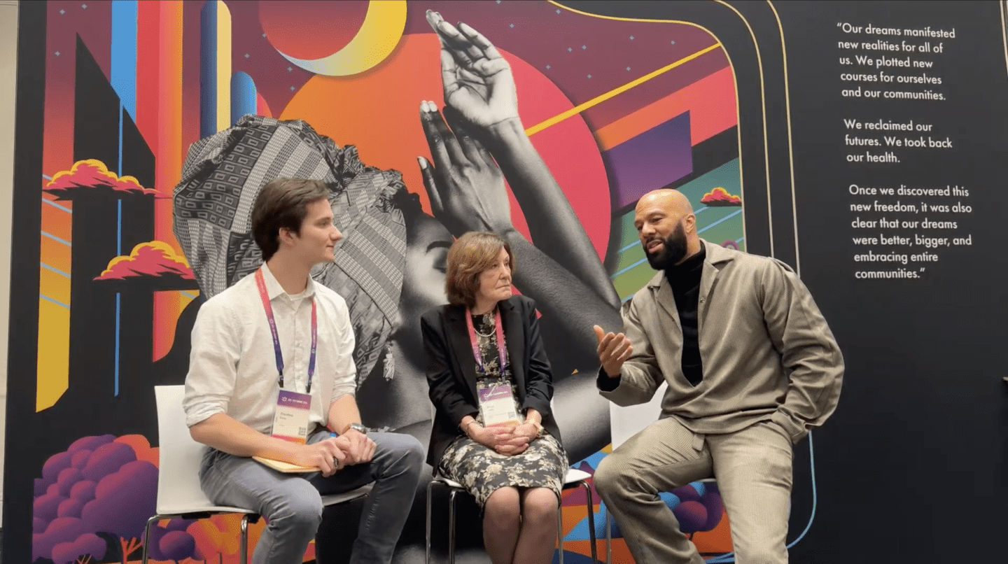 Preston Fore, Jean Eddy, and Common sit behind the Free to Dream graphics, discussing the new campaign