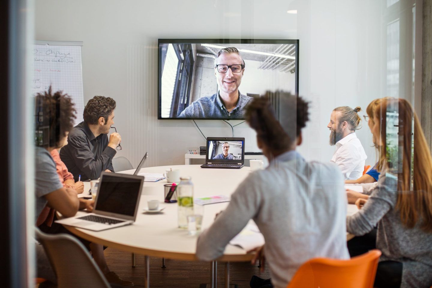 Several people in an office having a video meeting