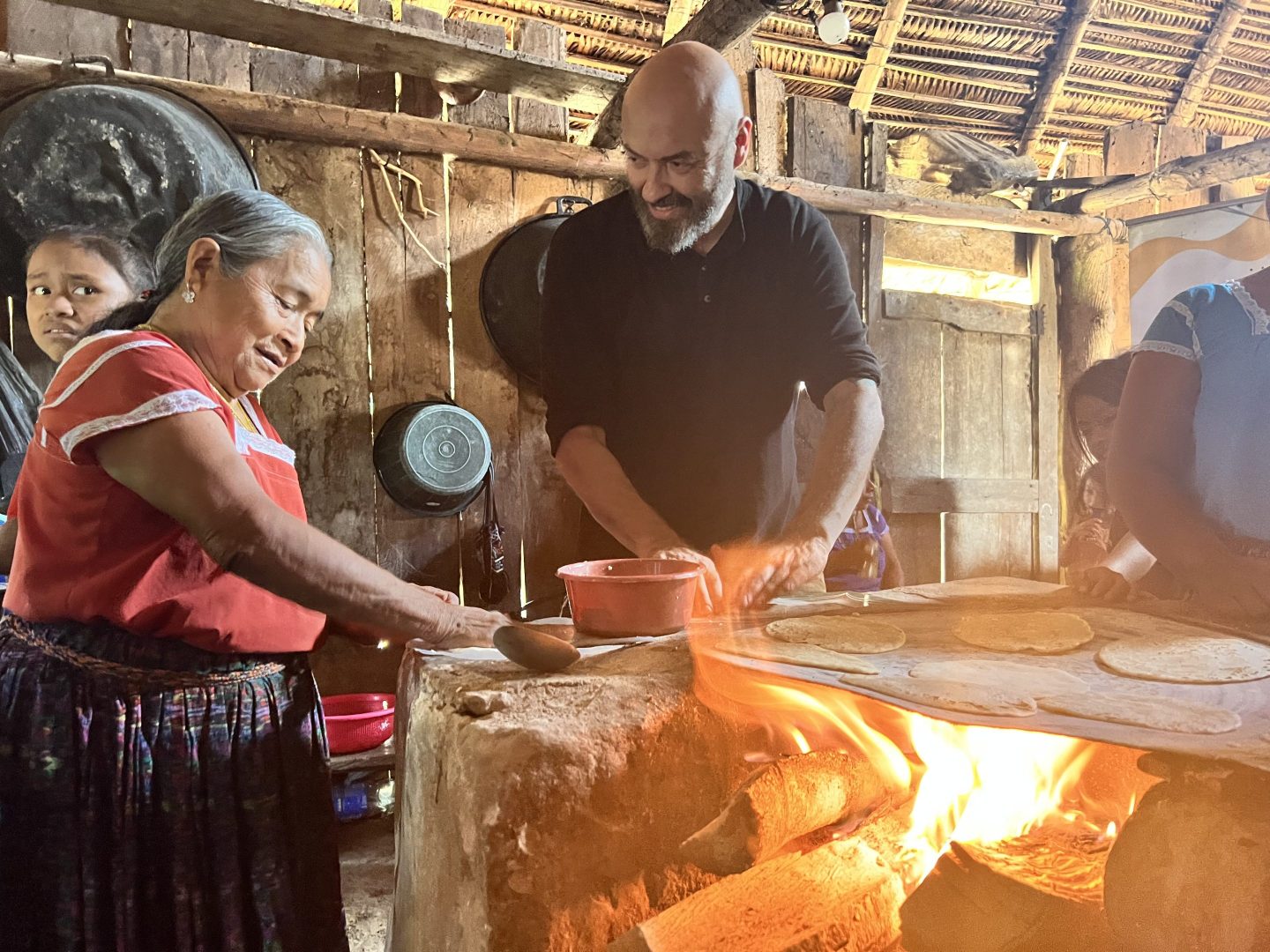Andres Torres cooks in Guatemala with a local family over an open flame.
