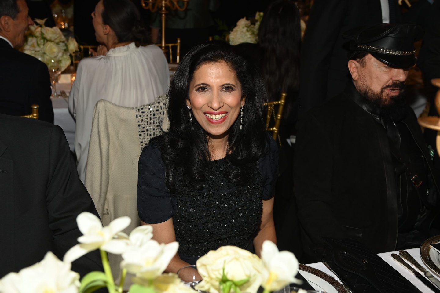leena nair smiling at a table