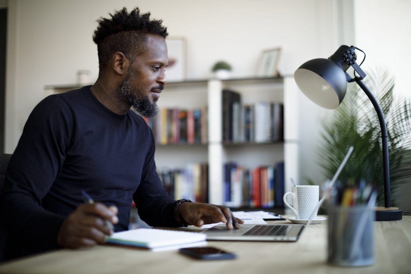 Smiling man working at home.