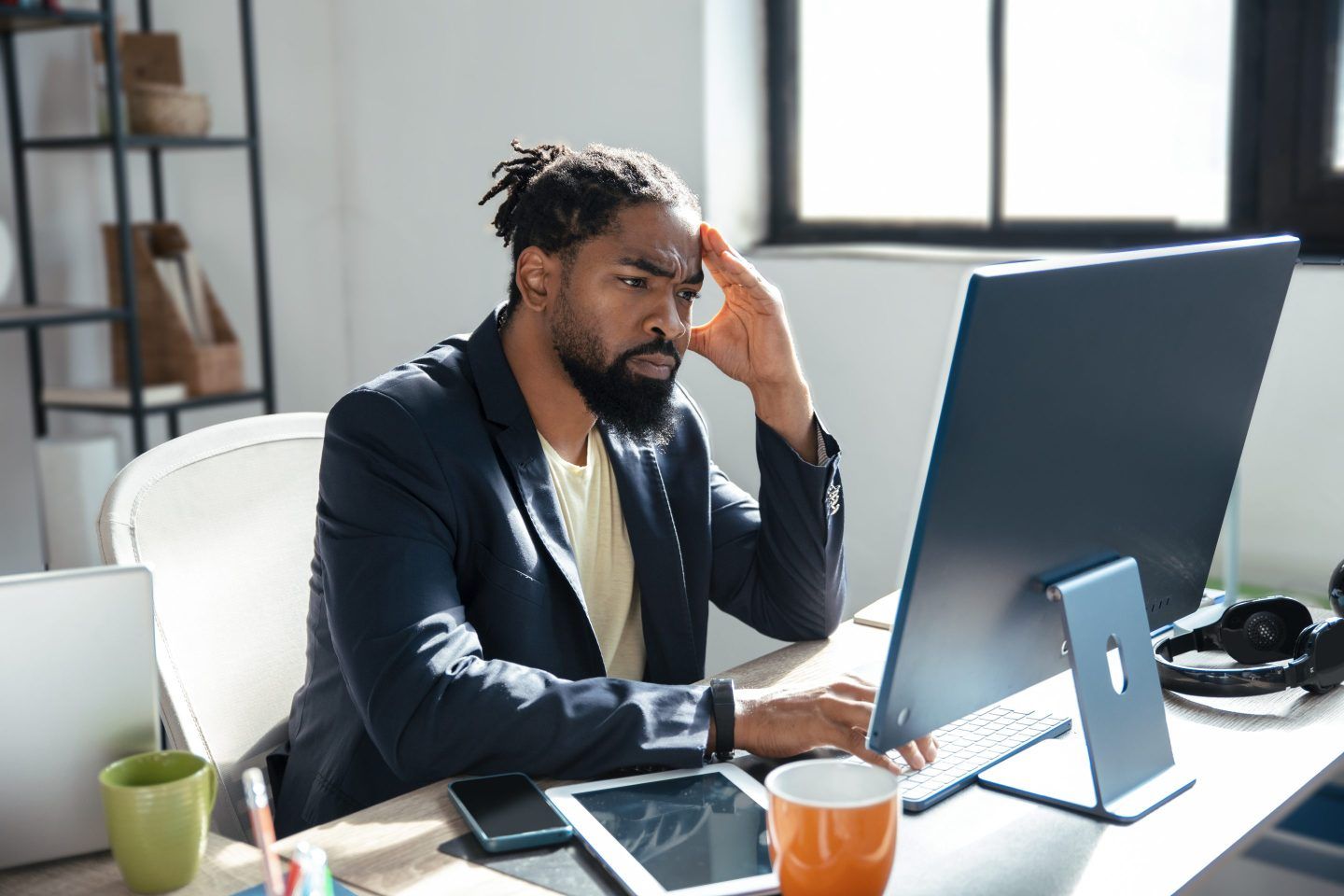 Young Businessman having trouble working at his PC in the workplace