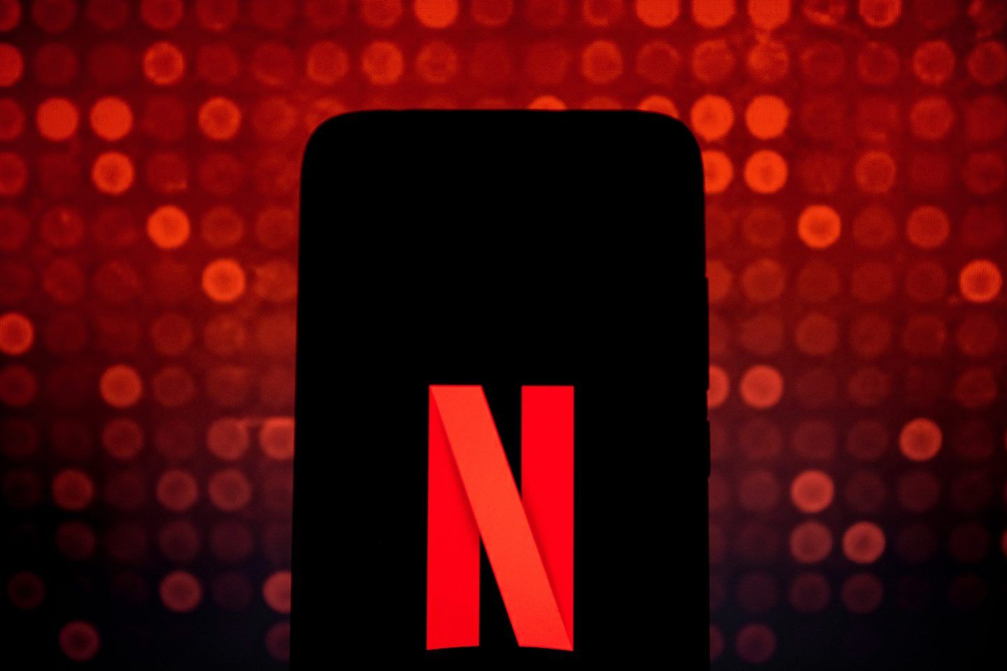 In this photo illustration Netflix logo is displayed on a smartphone screen