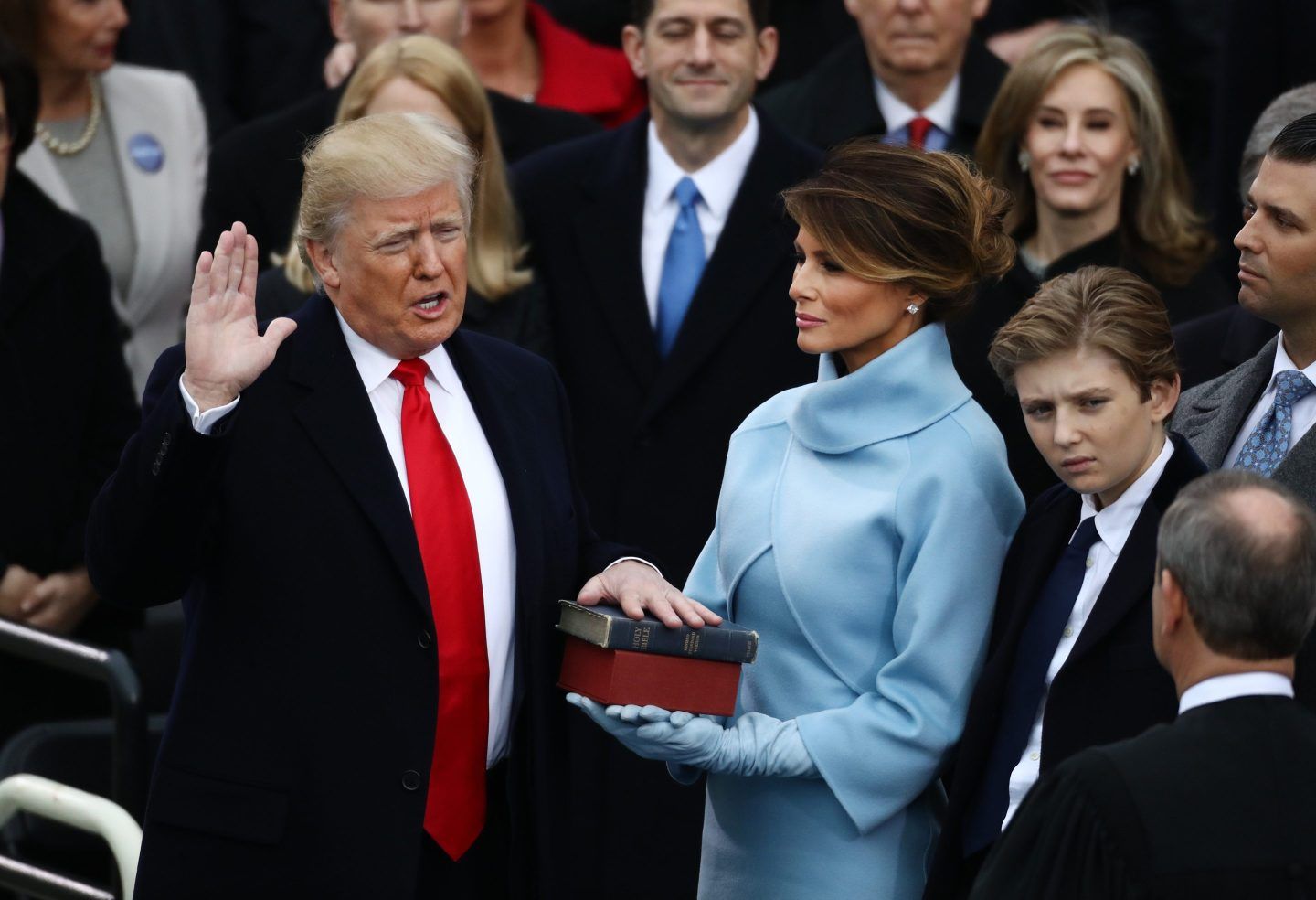 Trump holds up his hand as he's sworn in during his inauguration in 2017