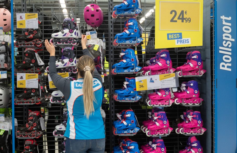 an employee organizing a rack of roller skates
