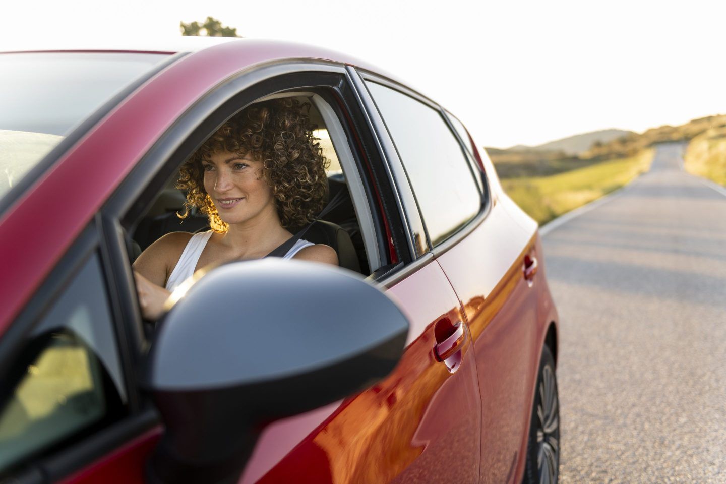 Woman sitting in the driver's seat of a car