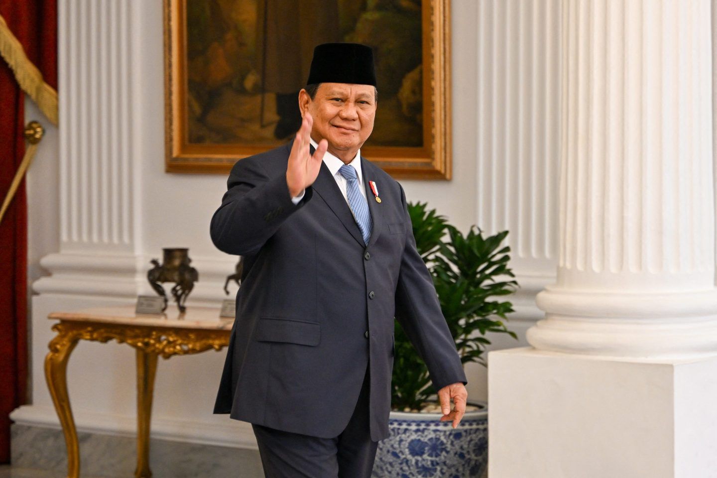 Indonesia's President Prabowo Subianto greets journalists before receiving his state guests at the presidential palace in Jakarta on October 21, 2024. 
