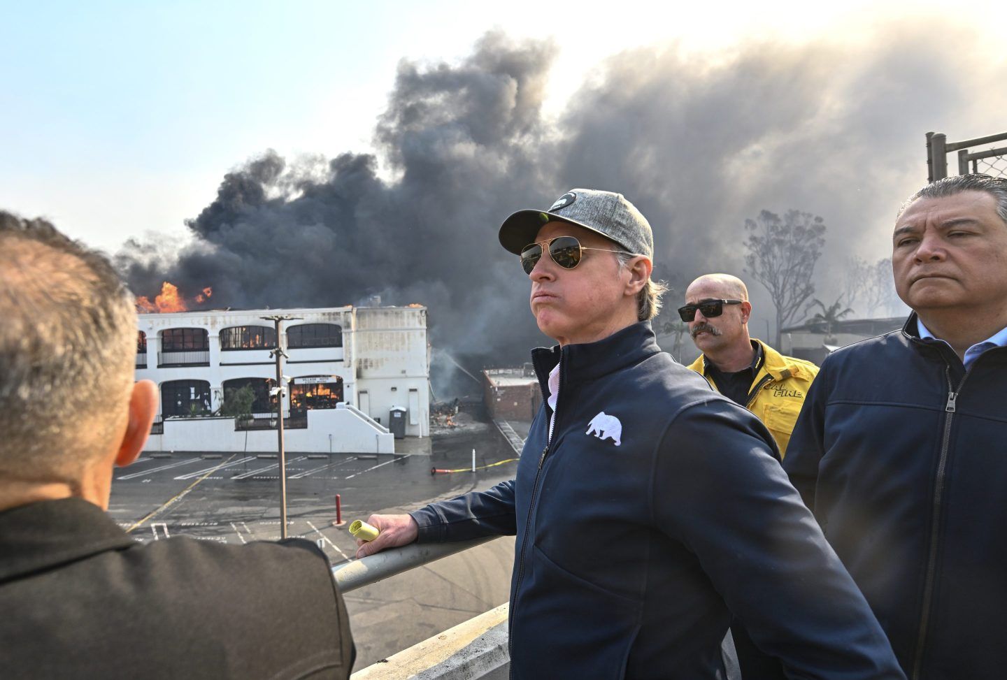 California Gov. Gavin Newsom, left, surveys damage in Pacific Palisades with CalFire's Nick Schuler, center, and Sen. Alex Padilla on Wednesday.
