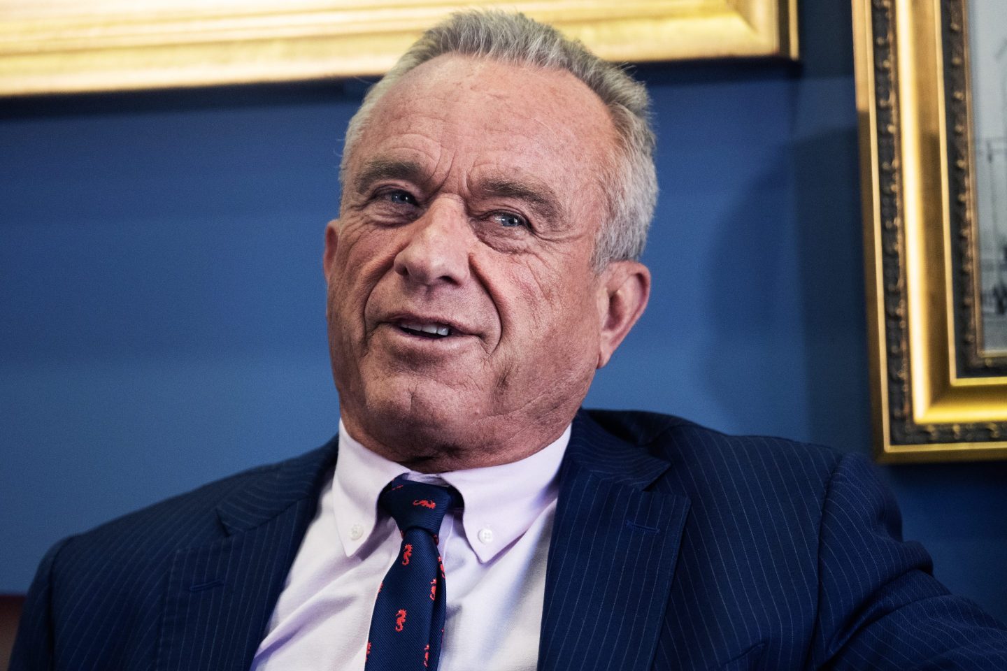 Close up of RFK Jr. speaking against a blue background