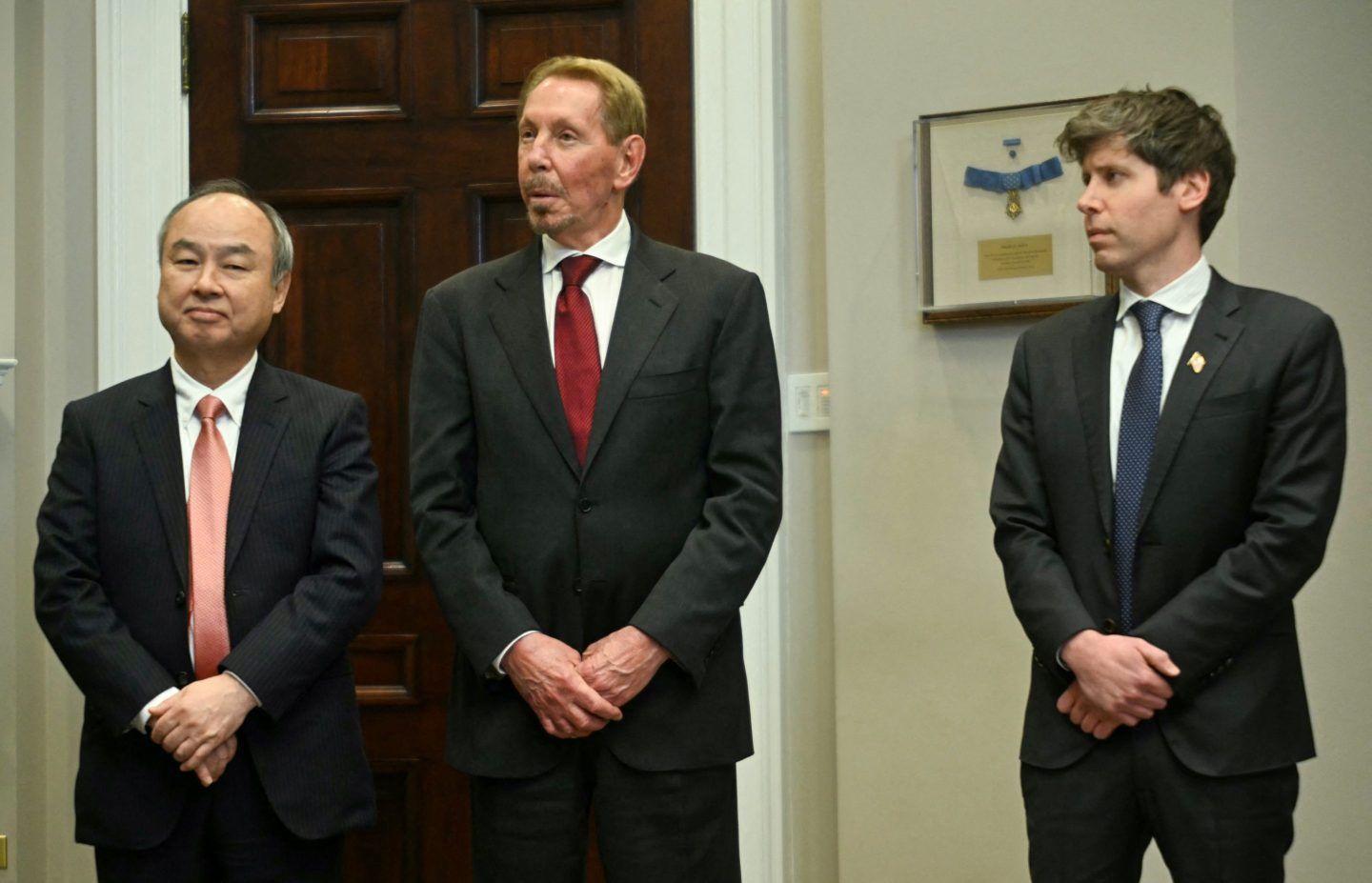 Masayoshi Son (L), Chairman and CEO of SoftBank Group Corp, Larry Ellison (C), Executive Charmain Oracle and Sam Altman (R), CEO of Open AI listen to US President Trump speaks in the Roosevelt Room at the White House on January 21, 2025, in Washington, DC.