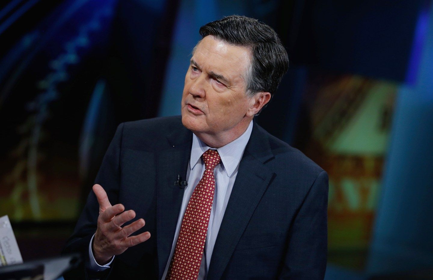 Dennis Lockhart, wearing a suit and tie, mid-sentence speaking during an interview