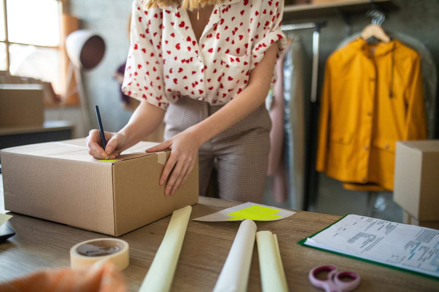 Young female entrepreneur working in her fashion e-commerce shop