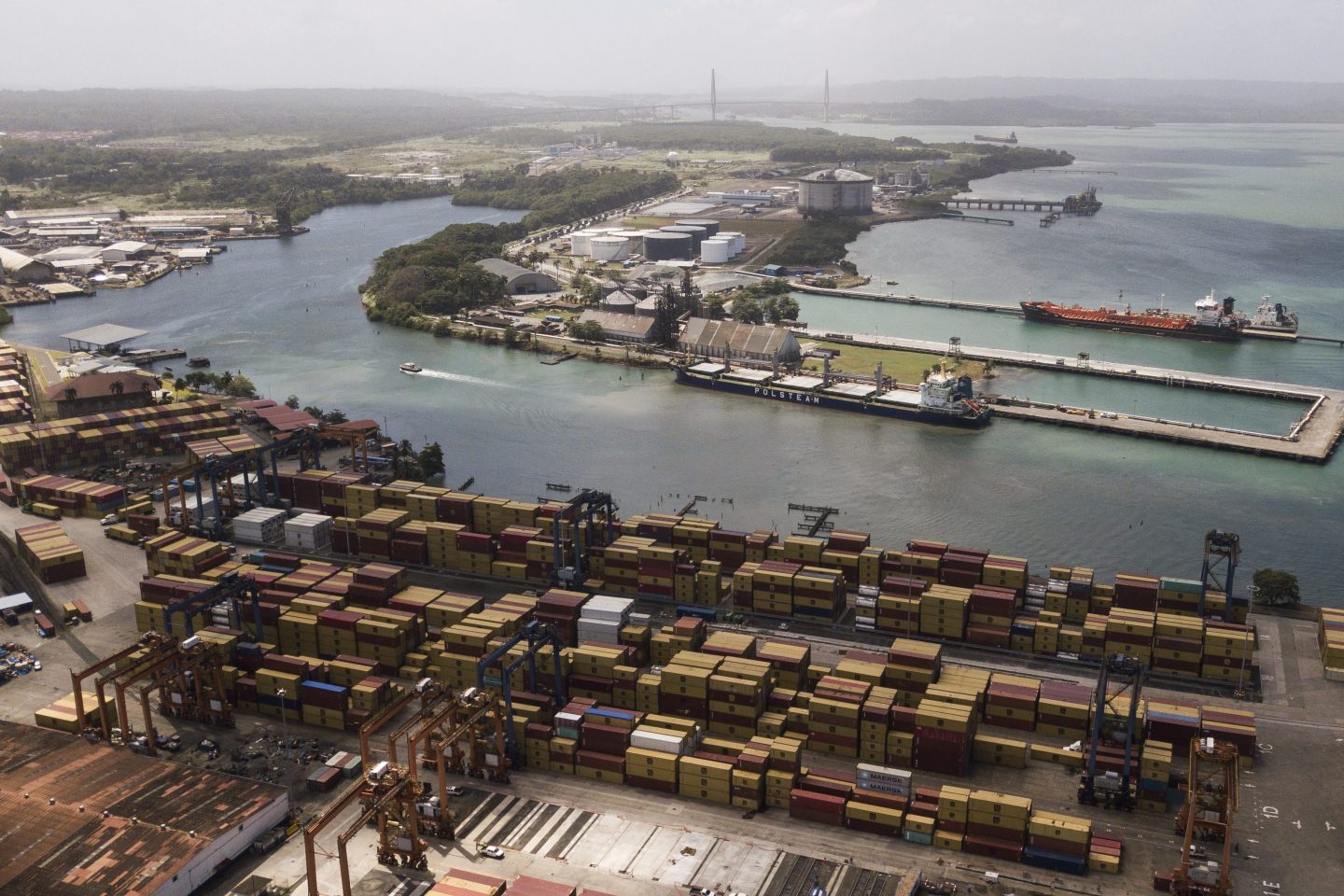 Cargo containers sit stacked as cranes load and unload containers from cargo ships at the Cristobal port, operated by the Panama Ports Company, in Colon, on Panama, Feb. 4, 2025. 