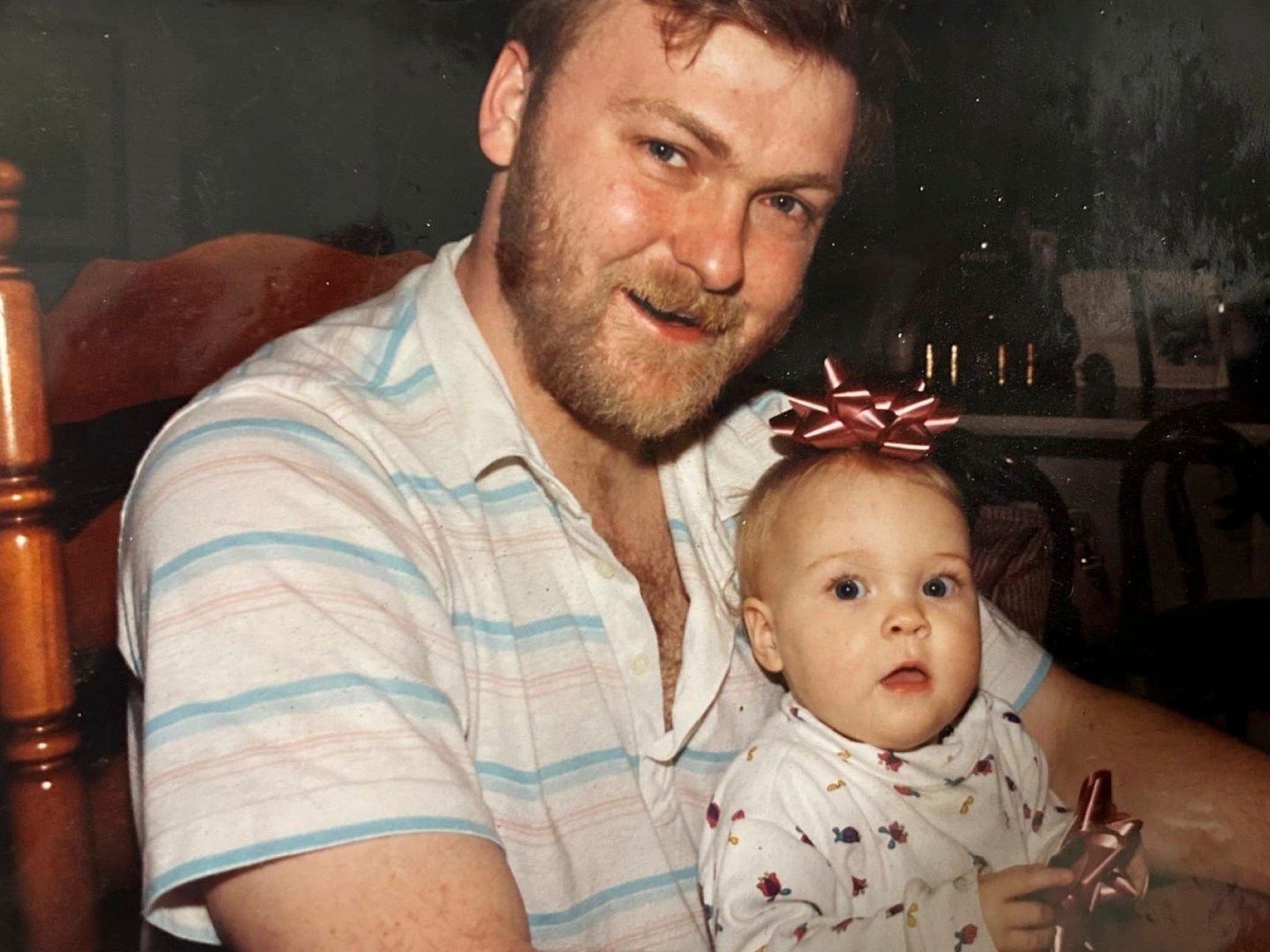 Photo of a man holding a small baby