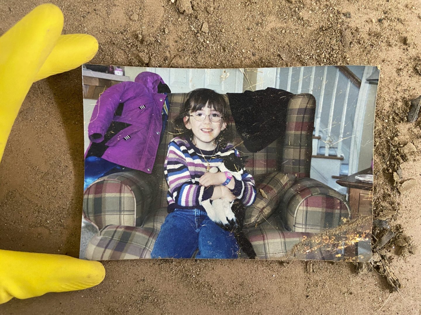 A photo of a young girl holding her pet, unearthed from the debris of Hurricane Helene