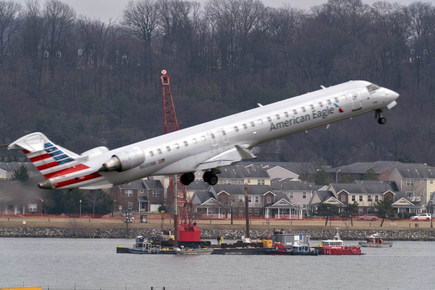 Salvage crews work on recovering wreckage near the site in the Potomac River of a mid-air collision between an American Airlines jet and a Black Hawk helicopter at Ronald Reagan Washington National Airport, on Feb. 6, 2025, in Arlington, Va. 