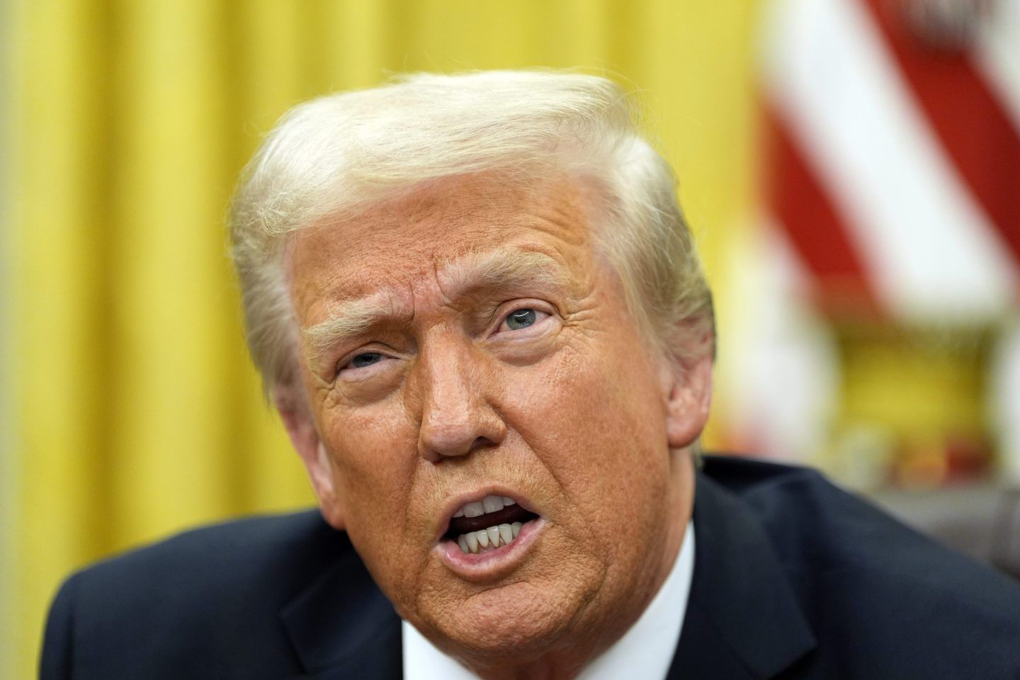 President Donald Trump speaks with reporters as he signs executive orders in the Oval Office at the White House, on Feb. 10, 2025, in Washington.