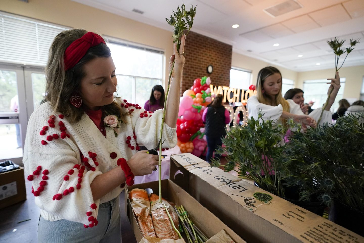 A volunteer cuts flowers to deliver to widows