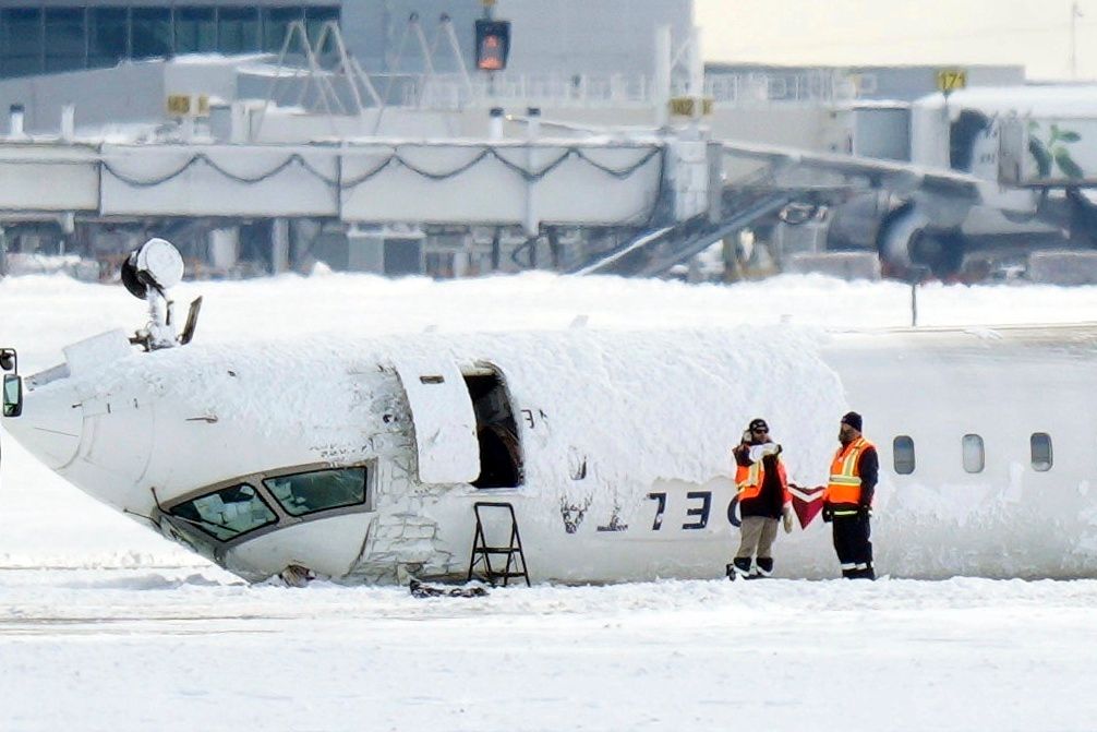 A Delta Air Lines plane lies upside down at Toronto Pearson Airport on Feb. 18, 2025. 
