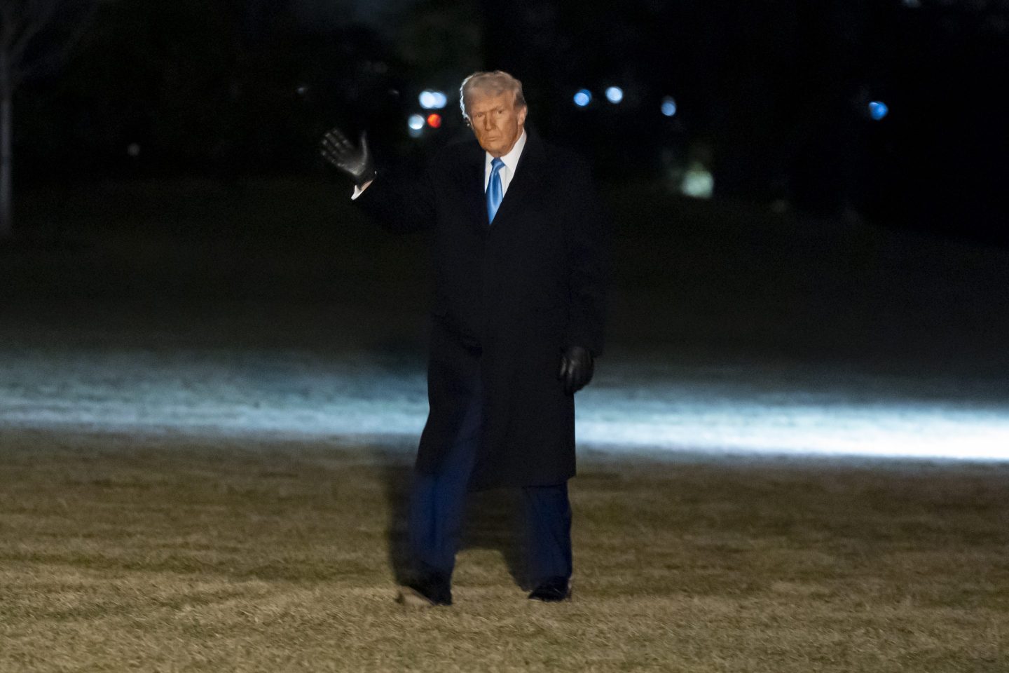 President Donald Trump waves as he walks from Marine One after arriving on the South Lawn of the White House, on Feb. 19, 2025, in Washington.