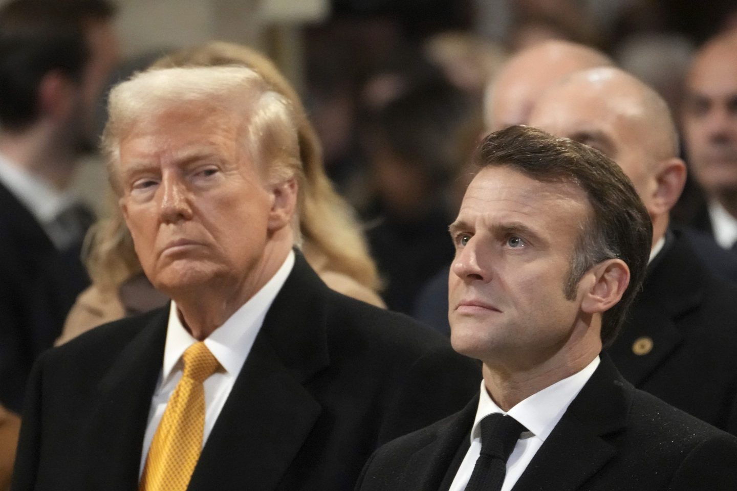 President-elect Donal Trump looks at France's President Emmanuel Macron in Notre Dame Cathedral, Dec. 7, 2024, in Paris. 