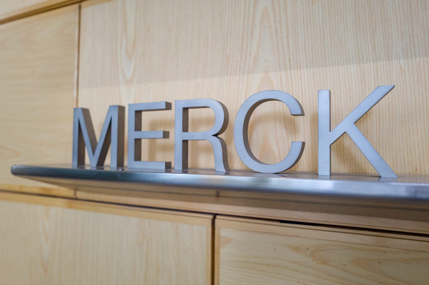 Close-up of cast metal sign for the pharmaceutical company Merck