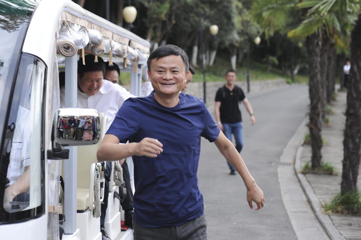 Jack Ma runs beside a truck