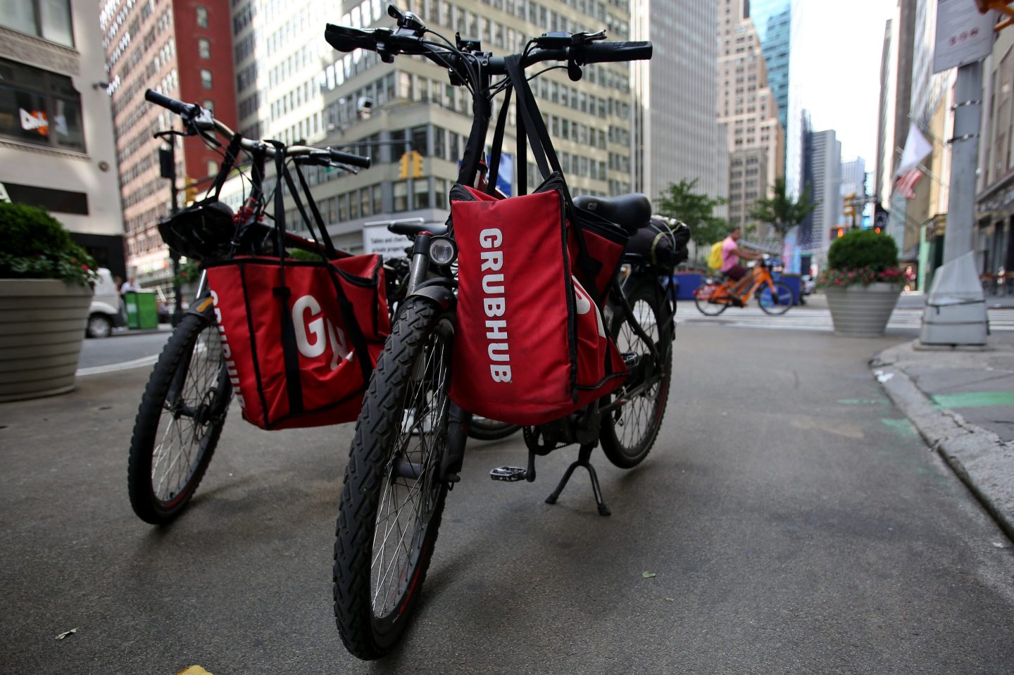 Parked delivery bikes with GrubHub bags