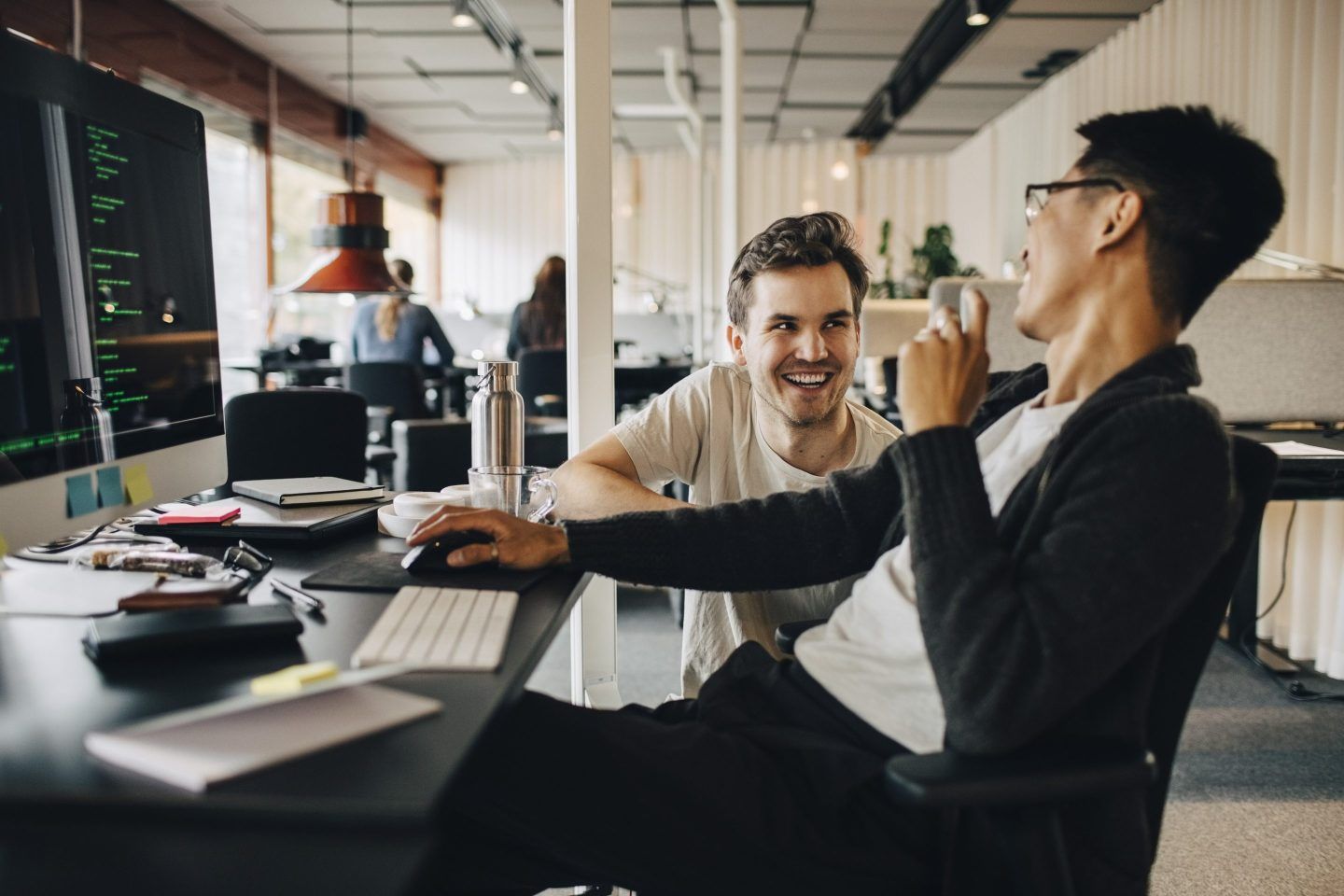 young workers talking at their desks