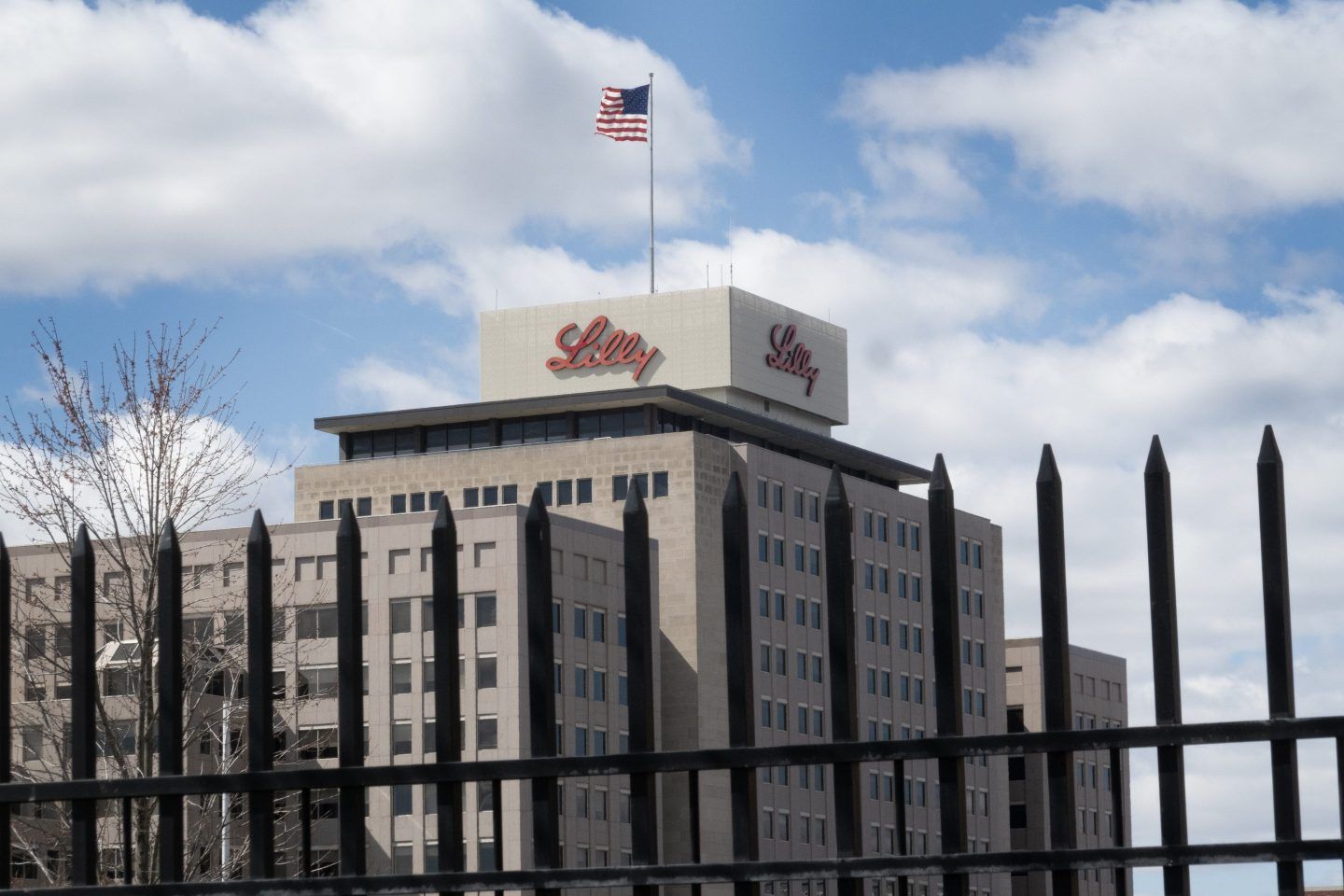 Eli Lilly's headquarters sits behind a gate with the US flag raised