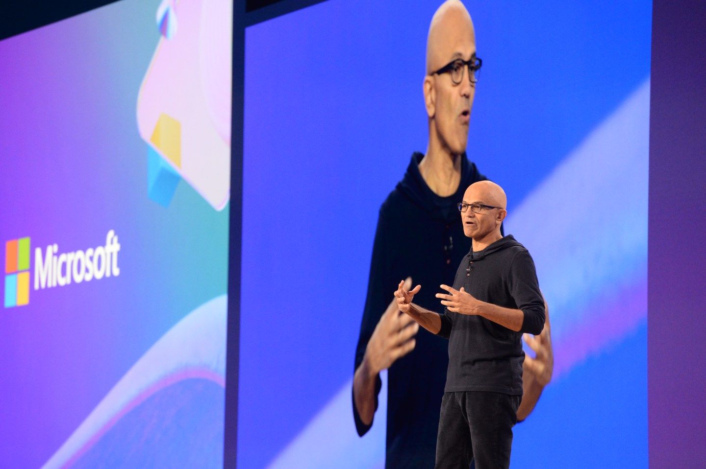 Microsoft CEO Satya Nadella speaks on stage.
