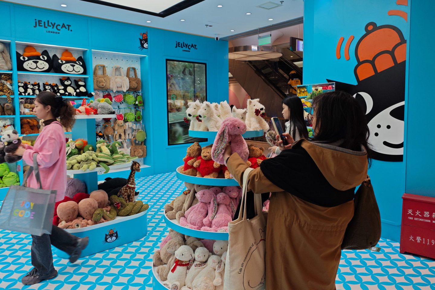 Gen Z consumer takes picture of Jellycat in store.