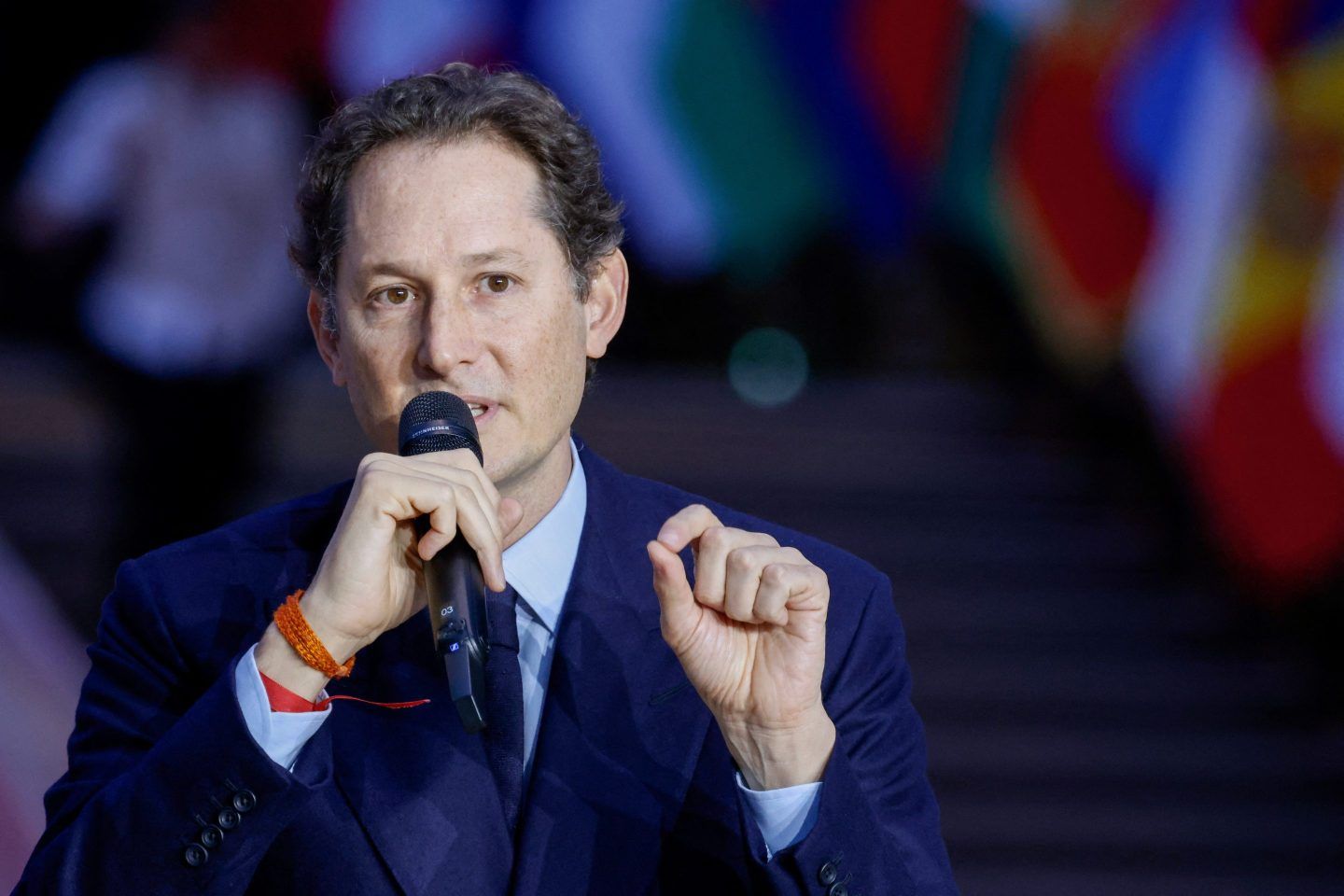 Chariman of Stellantis, chairman of Ferrari and CEO of Exor John Elkann (R) speak during the Artificial Intelligence (AI) Action Summit, at the Grand Palais, in Paris, on February 10, 2025.