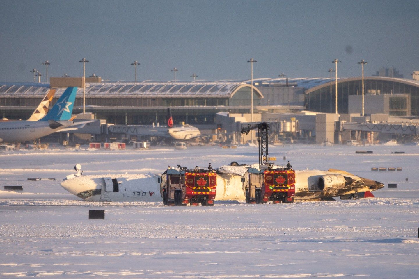 Photo: TORONTO, CANADA - FEBRUARY 17: Emergency personnel work at the scene of a Delta Airlines plane crash at Toronto Pearson International Airport on February 17, 2025 in Toronto, Canada. Several passengers were injured on the flight arriving from Minneapolis, resulting in the suspension of all flights at Canada's busiest airport. (Photo by Katherine KY Cheng/Getty Images)