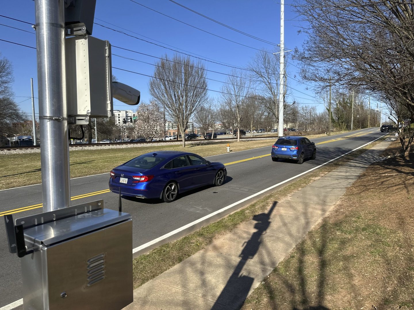 A speed camera tracks cars driving on a Georgia street