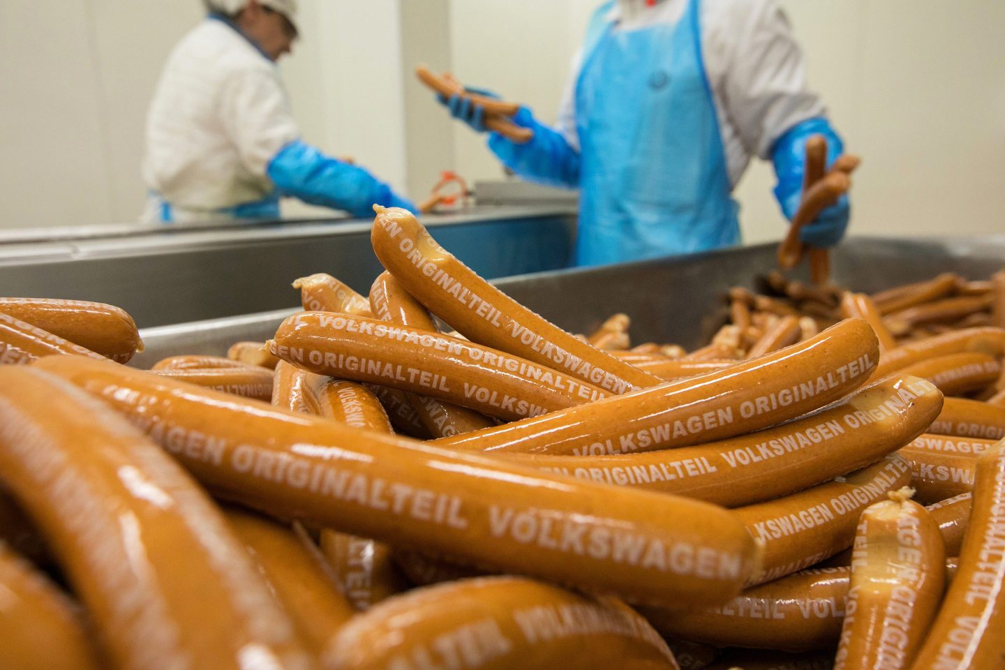 Employees package beech wood smoked currywurst sausages on the production line in the Volkswagen AG (VW) manufacturing plant in Wolfsburg, Germany, on Thursday, March 12, 2020. This week VW made its highest employee bonus payment since 2015, the automaker's works council said in a staff newsletter.