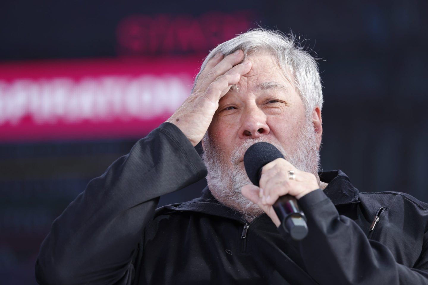 Steve Wozniak holding a microphone