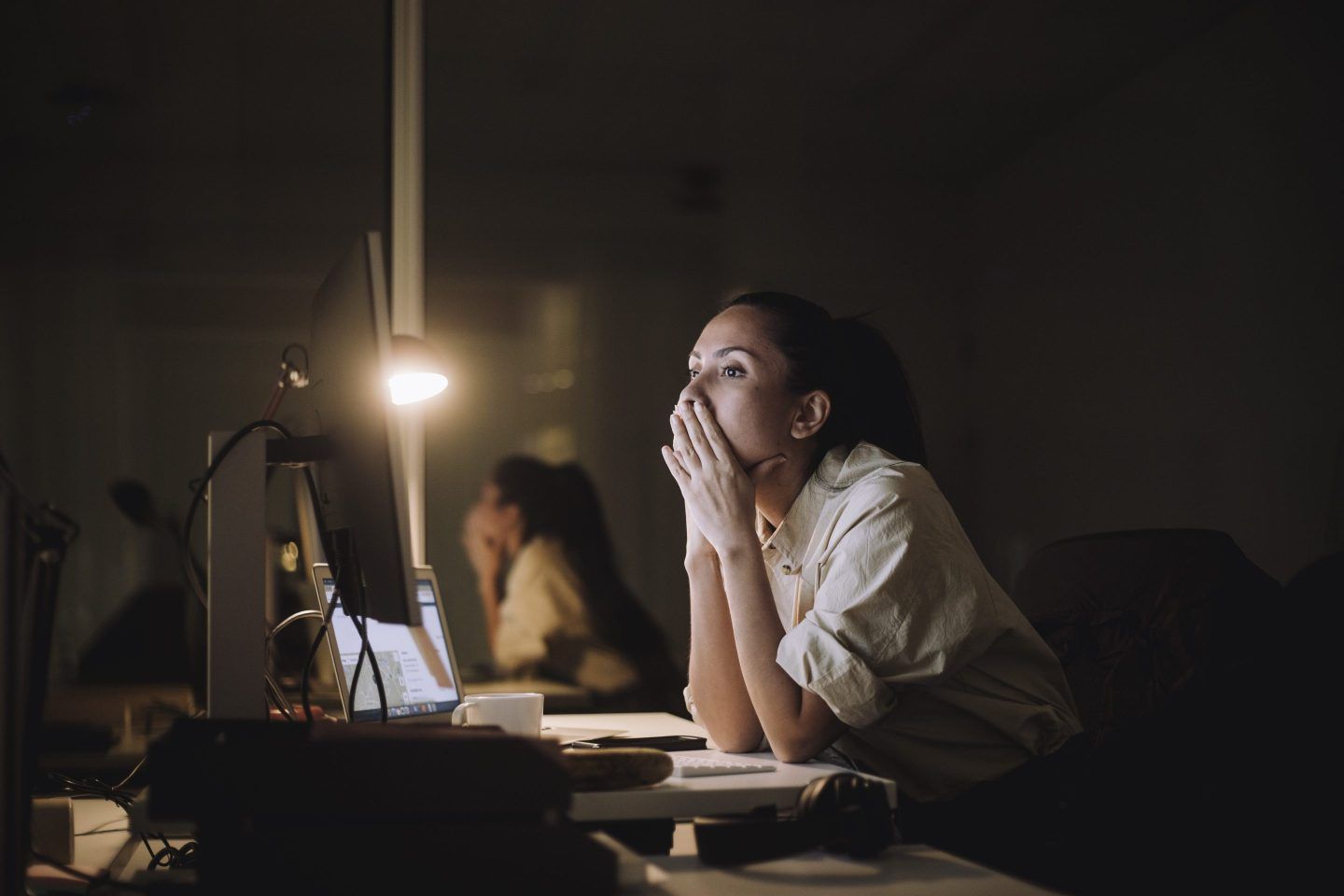 Businesswoman working late at night at office.